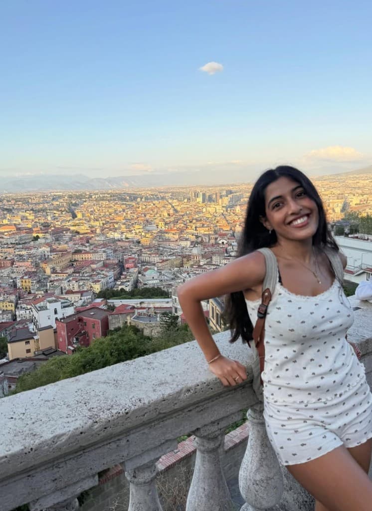 Chaitali with a view over the city at golden hour